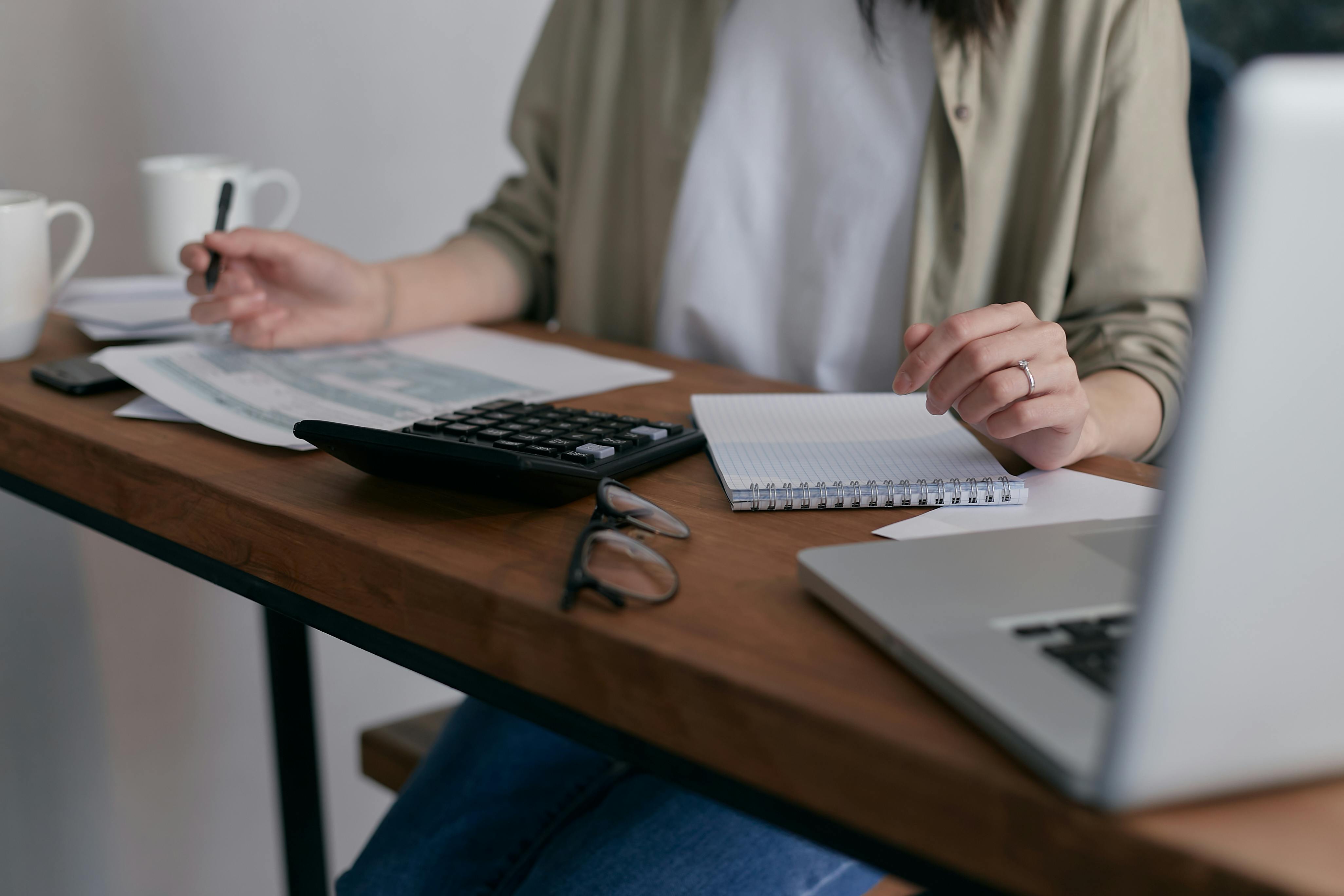 Calculator and documents on the table | Source: Pexels