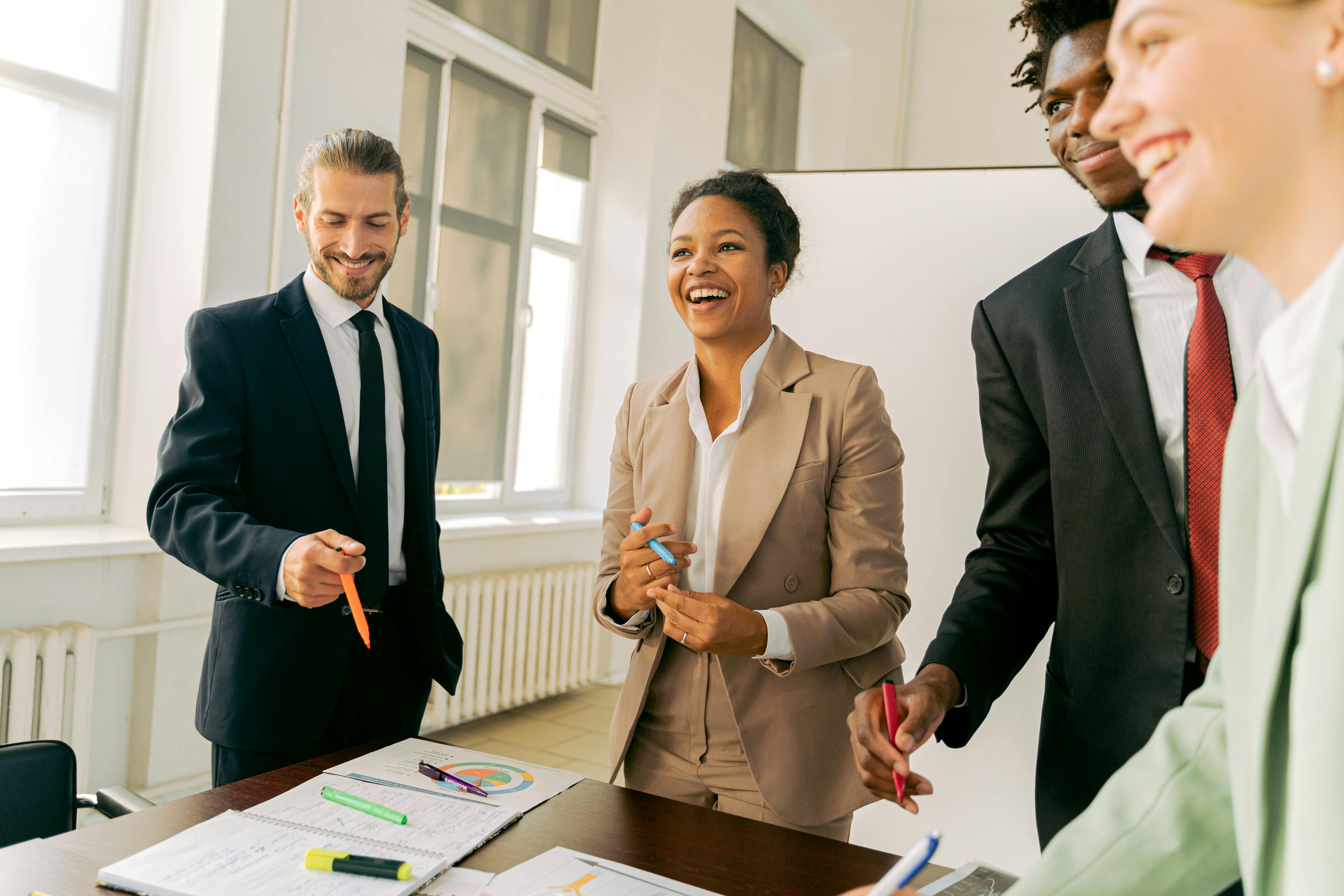Group of people smiling in an office | Source: Pexels