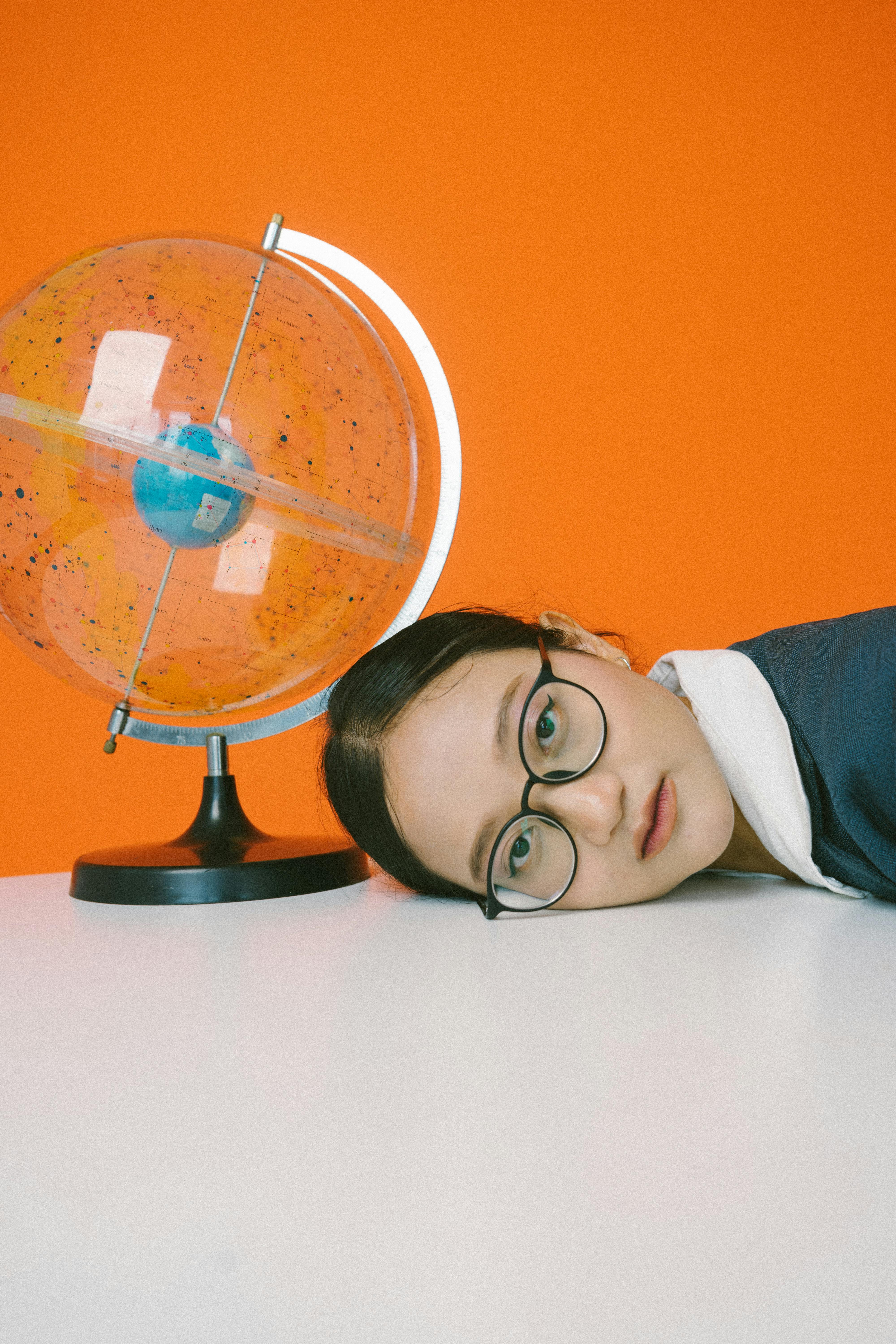Woman next to a globe | Source: Pexels