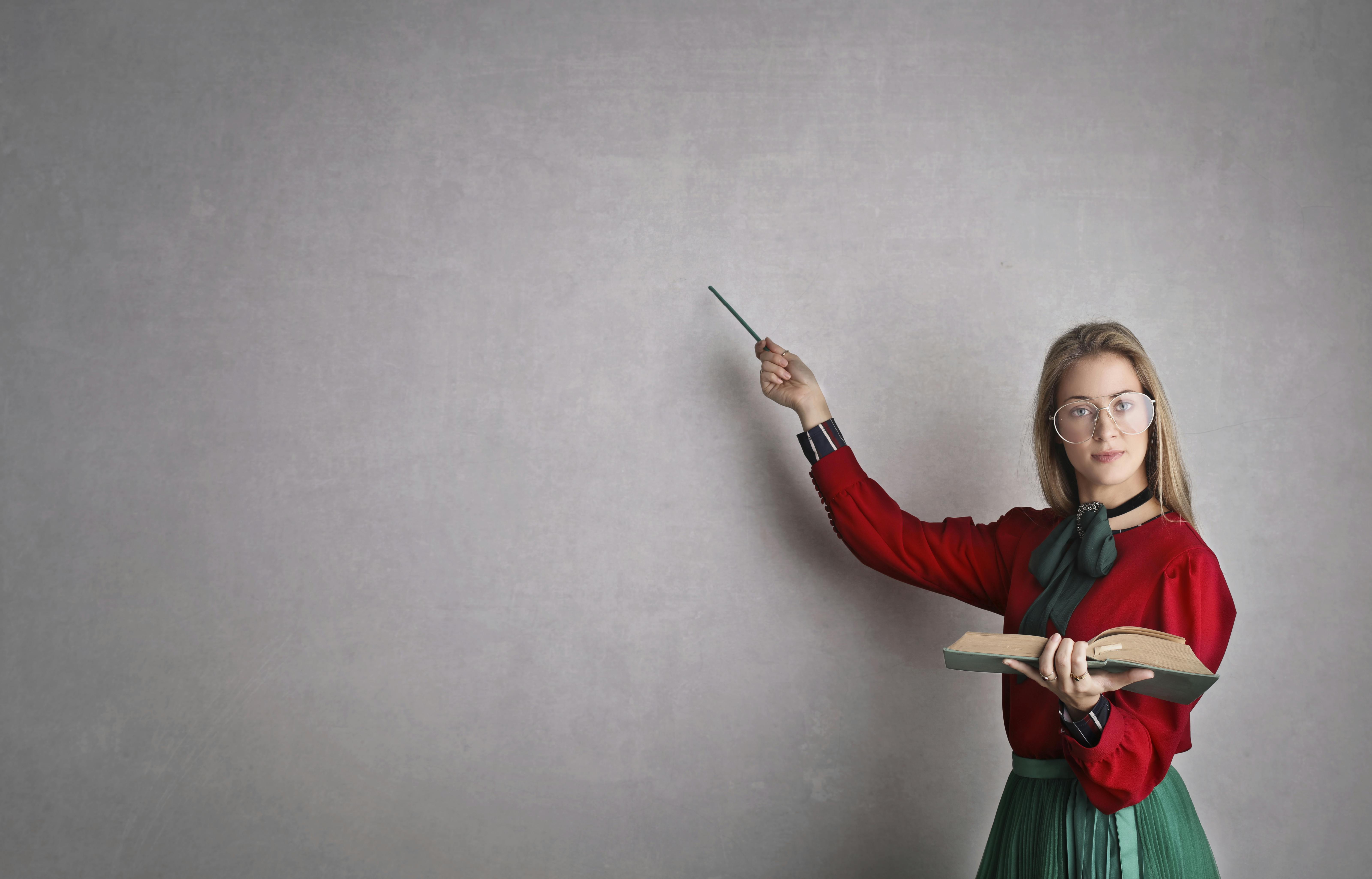 Woman holding a book | Source: Pexels