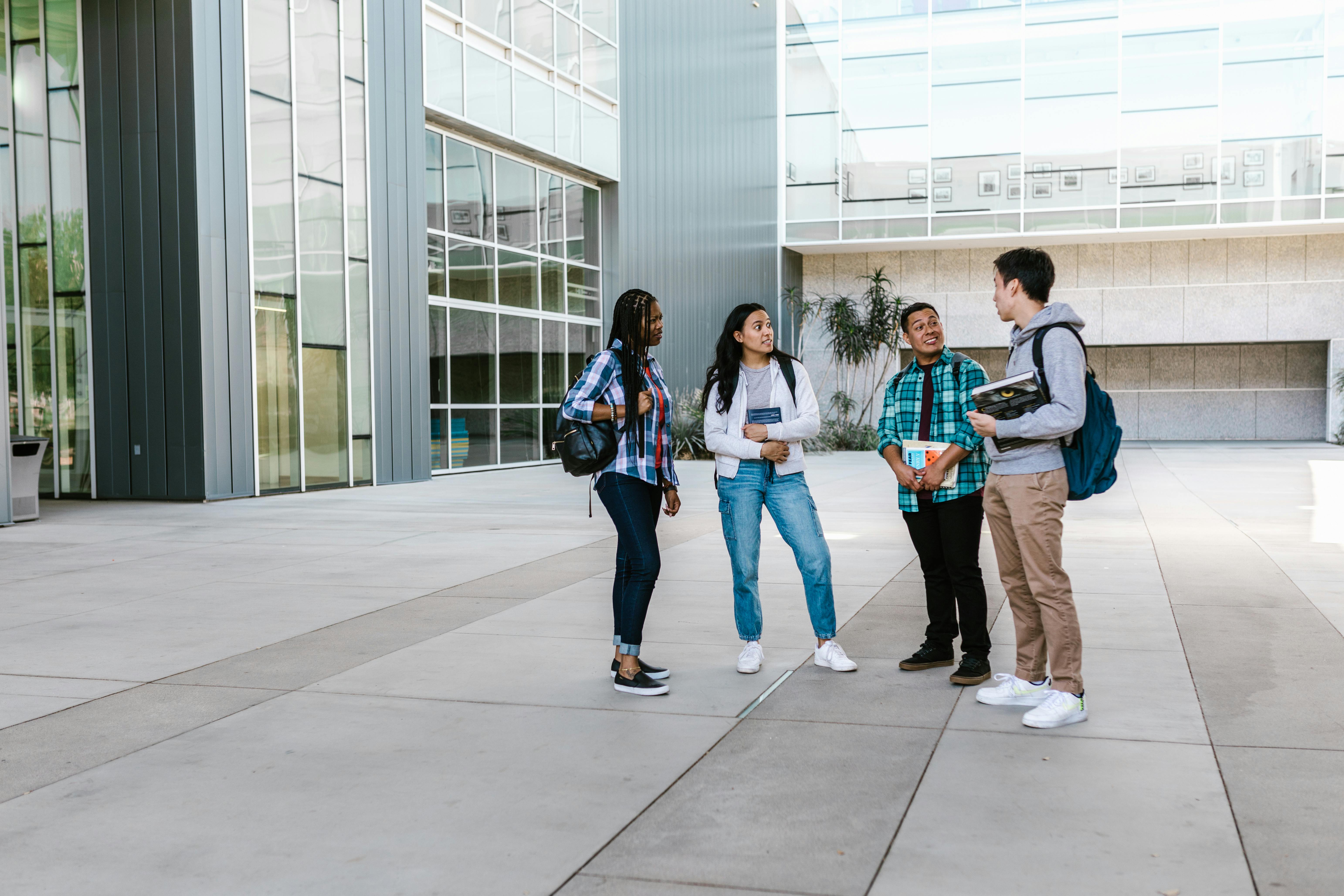 Students talking near a building | Source: Pexels
